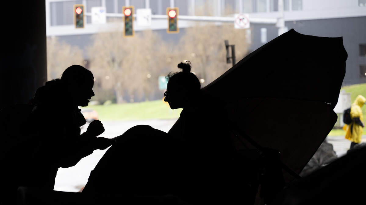 An outreach worker conducts a brief survey as part of the Point in Time Count under the Interstate-5 underpass on Bay Street, on Thursday, Jan. 29, 2026, in Tacoma. The Point in Time Count is a census of unhoused people that takes place nationwide on one day.