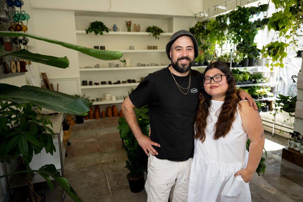 Co-owners Sarah Oh and Ryan McGowan pose for a portrait at Sunny’s, Thursday, Aug. 3, 2023, in Tacoma. The plant and home-goods store recently opened in downtown.