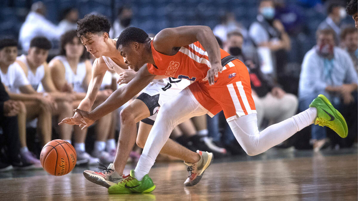 Graham-Kapowsin’’s Elijah Cain steals the ball from Davis point guard Brandon Lee Jr. during Wednesday afternoon’s opening-round game of the WIAA 4A Boys Basketball State Championships tournament in the Tacoma Dome in Tacoma, Washington, on Wednesday, March 2, 2022.