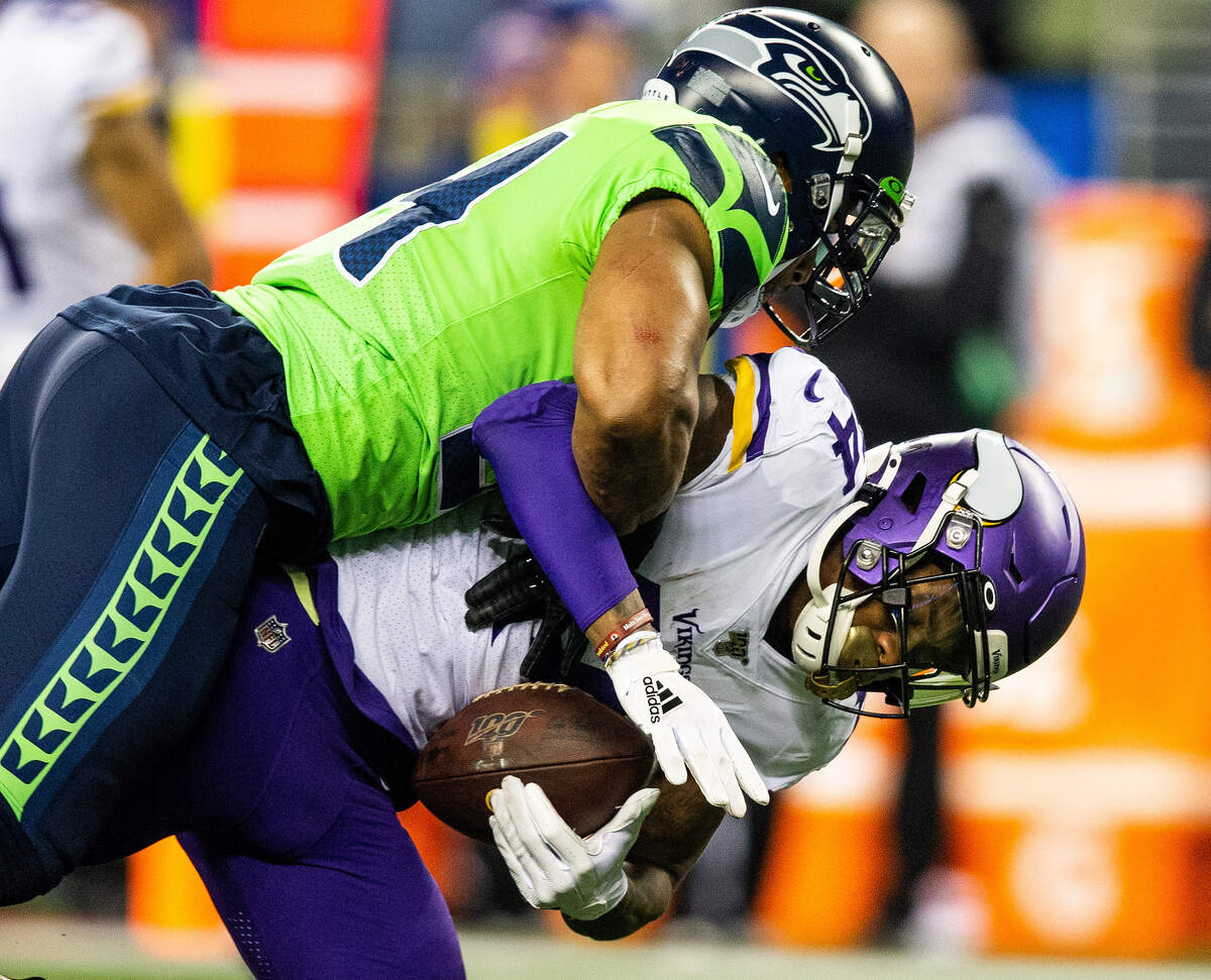 Seattle Seahawks middle linebacker Bobby Wagner (54) tackles Minnesota Vikings wide receiver Stefon Diggs (14) during the third quarter. The Seattle Seahawks played the Minnesota Vikings in a NFL football game at CenturyLink Field in Seattle, Wash., on Monday, Dec. 2, 2019.