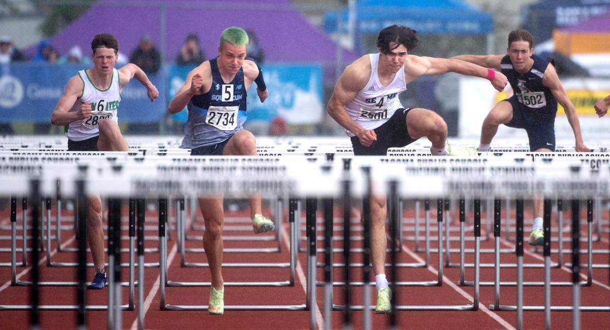 Squalicum’s Andre Korbmacher, left, tops Sehome’s Carter Birade to take the state championship in the 2A boys 110-meter high hurdles during the second day of the WIAA State Track and Field Championships at Mount Tahoma High School on Friday, May 27.