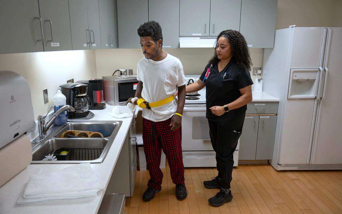 Leo Roberson of Graham works with occupational therapy assistant Aubre Smith as he prepares to return to his home after a stay in the Rehabilitation Center at Good Samaritan Hospital in Puyallup, Washington, on Thursday, Dec. 12, 2024.