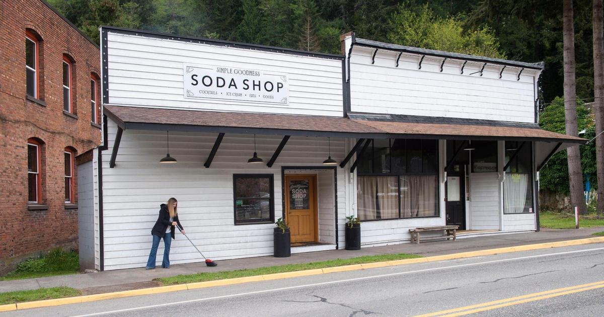 Simple Goodness Sisters co-owner Belinda Kelly sweeps the front walk of the Soda Shop. The cocktail bar/soda fountain will be reopening in Wilkeson. Photo taken on Thursday, May 6, 2021.