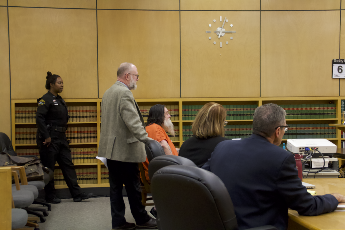 Henry William Hauser Jr., center, wearing orange, appears Friday, Oct. 6, 2023, in Pierce County Superior Court to be sentenced after a jury found him guilty of kidnapping a woman in 2021 and holding her captive in his garage. Hauser was sentenced to life in prison.