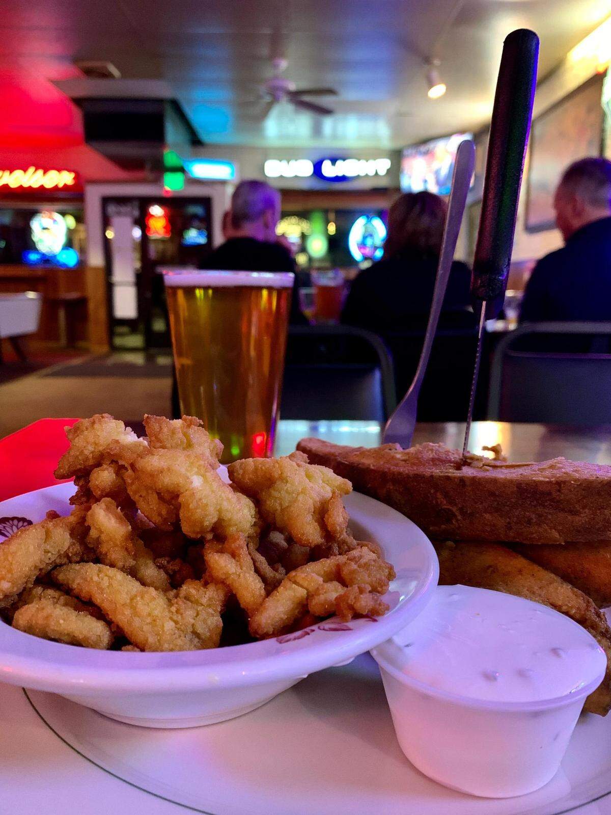 It’s more fun to hang inside Terry’s Office Tavern, but the food satisfies outside the bar, too. Fried goodies abound, including these clam strips with the bar’s signature jojos.