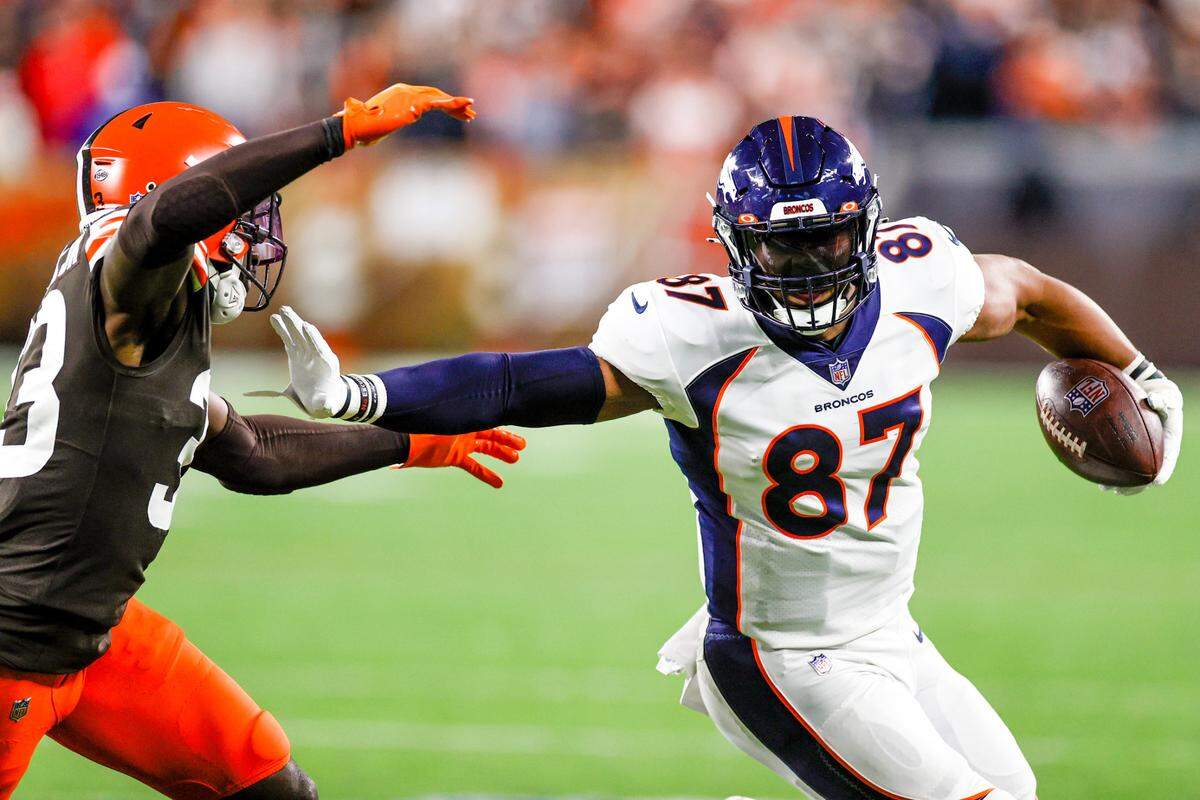 Denver Broncos tight end Noah Fant (87) plays against Cleveland Browns defensive back Ronnie Harrison (33) during the second half of an NFL football game, Thursday, Oct. 21, 2021, in Cleveland. (AP Photo/Ron Schwane)