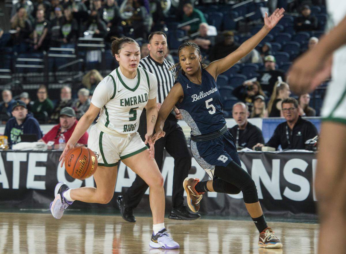 Emerald Ridge guard Monique Carter (5) drives as Bellarmine Prep guard Kiara Stone (5) defends in the consolation round of the Class 4A girls state basketball tournament on Friday, March 3, 2023 at the Tacoma Dome in Tacoma, Wash.