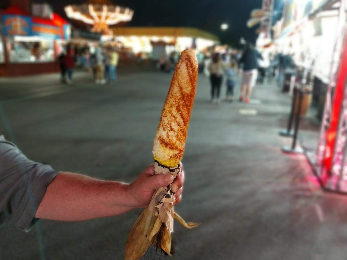 Street corn from Murph’s, a barbecue booth, at the Washington State Fair. At Murph’s, street corn can be doctored any way a diner wants with crushed cereals, chips, parmesan cheese, mayonnaise and a number of other flavorings.