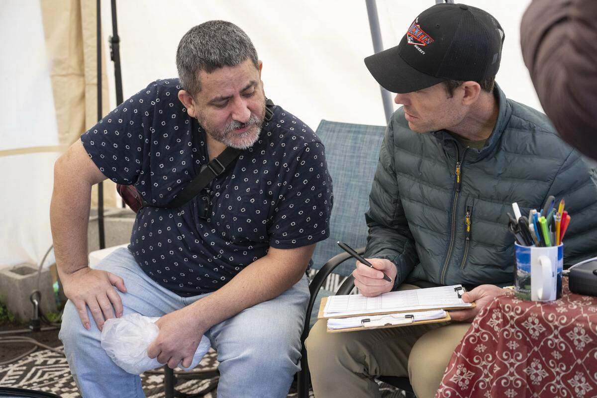 Recently released ICE detainee Alejandro Garcia, left, shares information with volunteer Chris Hallam at the welcome center run by Advocates for Immigrants in Detention Northwest on Friday, March 20, 2026, outside of the Northwest ICE Processing Center in Tacoma, Wash.