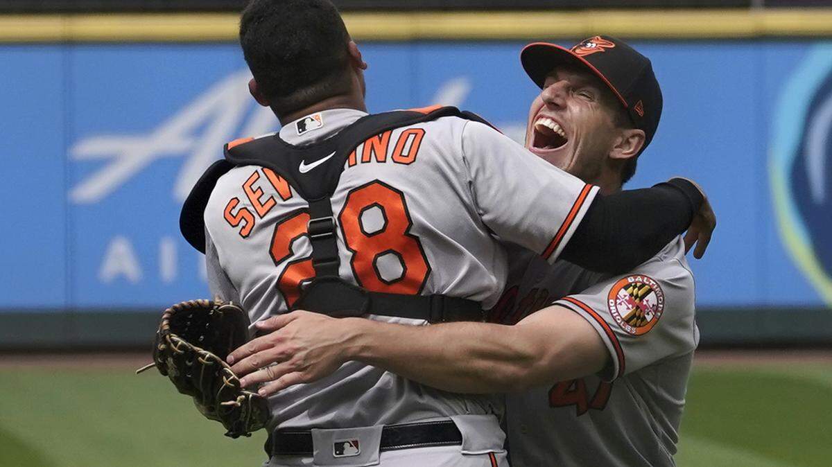 Baltimore Orioles starting pitcher John Means, right, hugs catcher Pedro Severino after Means threw a no-hitter in the team’s baseball game against the Seattle Mariners, Wednesday, May 5, 2021, in Seattle. The Orioles won 6-0. (AP Photo/Ted S. Warren)