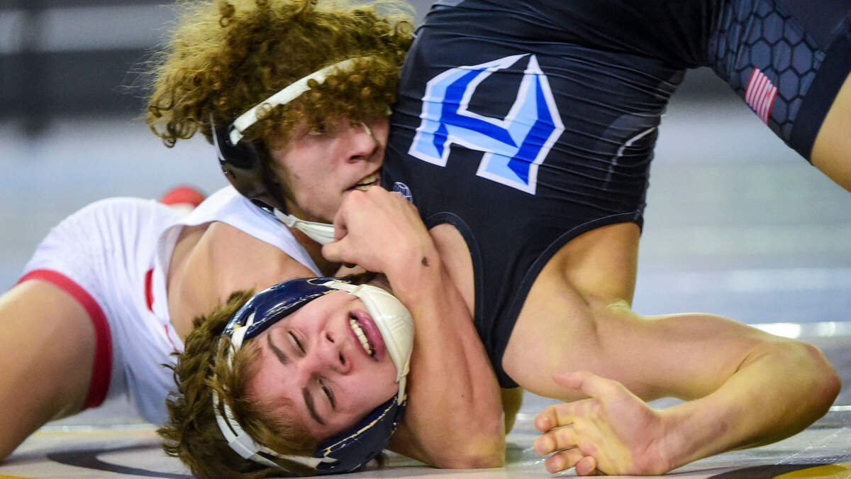 Orting’s Bryan Dickerson looks to put Hockinson’s Jake McKee on his back during their 126-pound 2A quarterfinal match at Mat Classic XXXIII on Friday, Feb. 18, 2022, in Tacoma, Wash. Dickerson won the match by technical fall, 15-0.