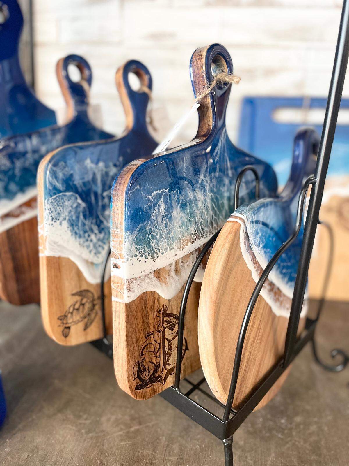 Co-owner of Local Whimsy, Caasi Dickens, is also a local maker. She pours ocean resin over items such as cutting boards and glasses. 