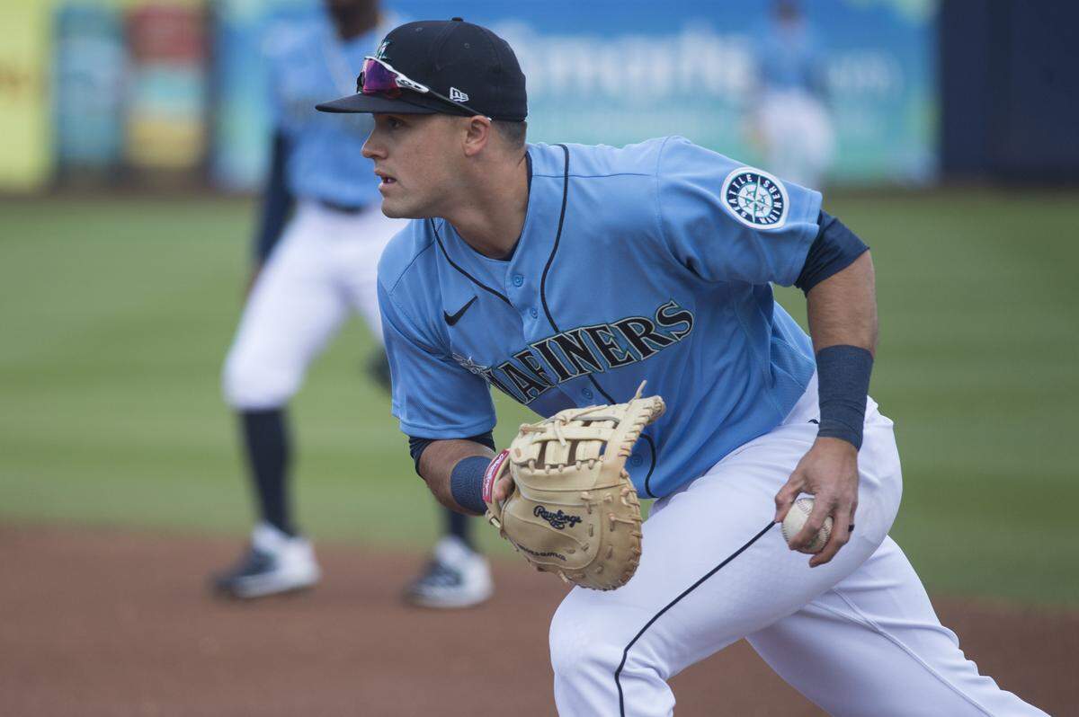 Seattle Mariners first baseman Evan White fields a ground ball for an out in a spring training game against the Rockies on Monday, March 2, 2020 at Peoria Stadium in Peoria, Ariz.