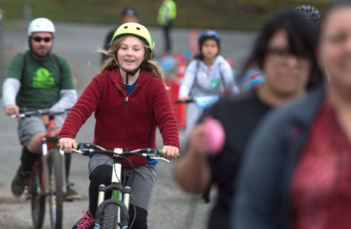 Joy Smith, 9, green helmet, rides her bike toward Tacoma on Sunday, Sept. 27, 2014. People can bike, walk, run, roll from Point Defiance Park to Downtown Tacoma and back. Downtown to Defiance is a free open streets event on Sunday, September 28 for bicyclists, walkers and runners to experience the waterfront for almost 7 miles unencumbered by vehicular traffic. The event starts and finishes at Point Defiance Park with a turnaround on the Foss Waterway Esplanade at S. 21st Street Park