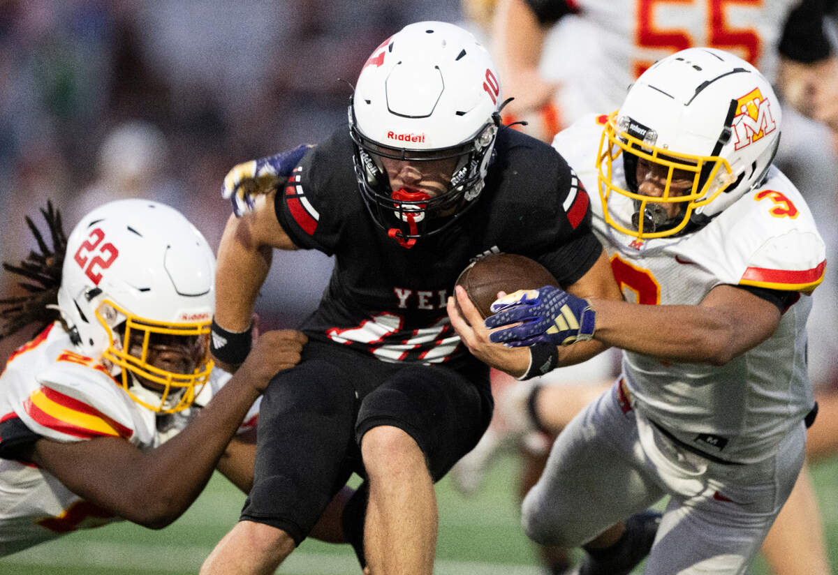 Yelm quarterback Parker Myers (10) is brought down by Mount Tahoma’s Keshawn Hines (22) and Felix Diaz (3) during the first half of the game at Yelm High School, on Thursday, Sept. 5, 2024, in Yelm, Wash.