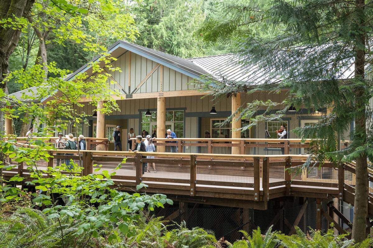 People move along the back deck of the new rentable event space at Kopachuck State Park on Friday, Aug. 1, 2025, ahead of the renovated park's reopening on Saturday near Gig Harbor, Wash.