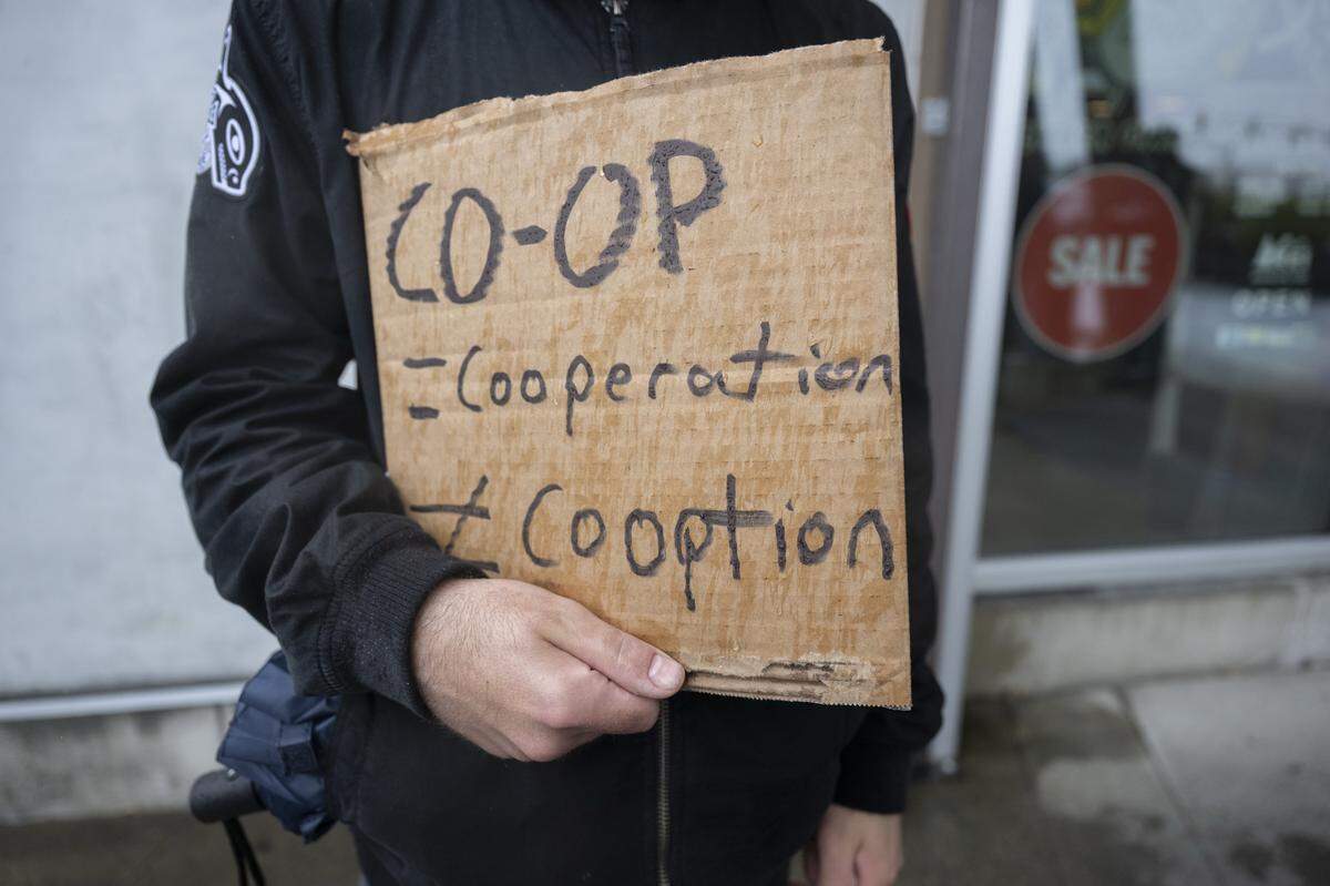 Picketers stand outside of an REI Co-op location in support of REI Union workers on Friday, May 15, 2026, in Tacoma, Wash.