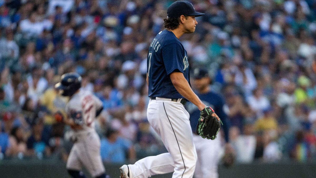 Seattle Mariners starting pitcher Marco Gonzales (7) reacts as Houston Astros second baseman Jose Altuve (27) rounds third base after hitting a lead-off home run in the top of the first inning of a Major League Baseball game on Friday, July 22, 2022, at T-Mobile Park in Seattle.