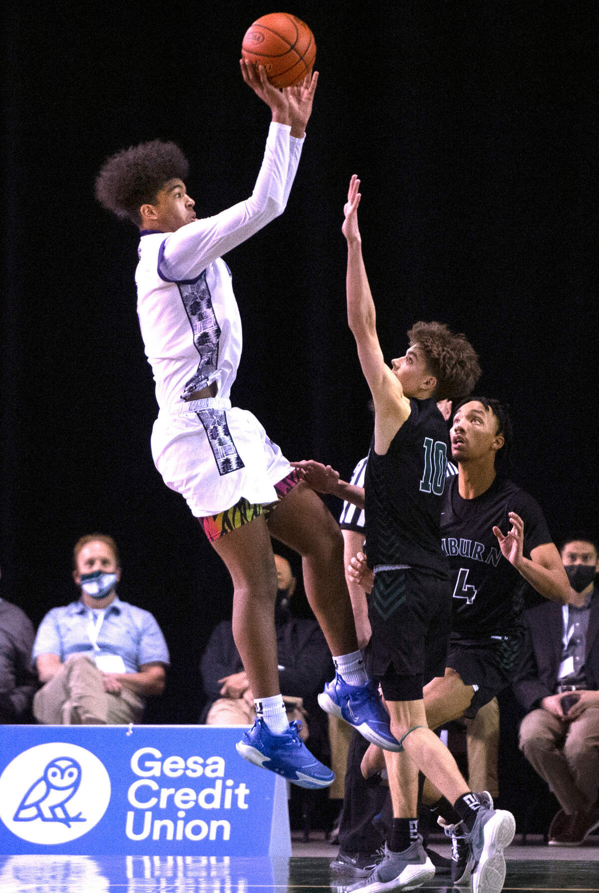 Garfield’s Jaylin Stewart puts up a final shot over Auburn defenders Hansen Kaden and Semaj Brown (4) during Thursday morning’s quarterfinal game of the WIAA 3A Boys Basketball State Championships tournament in the Tacoma Dome in Tacoma, Washington, on Thursday, March 3, 2022. Auburn won in overtime, 64-60.
