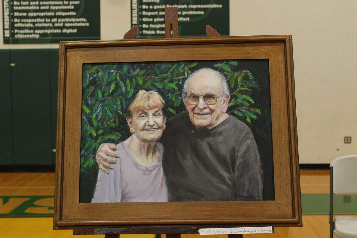 A portrait of Hugh and Janice McMillan sat at the front of the Peninsula High School gymnasium during the celebration of Hugh McMillan’s life.