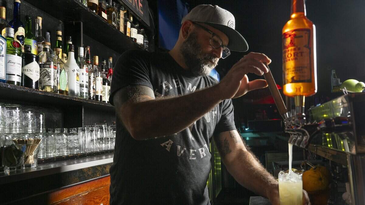 Owner Sam Halhuli pulls on a ginger beer tap behind the bar of The Mule Tavern to make a Randy Buck on Wednesday, July 8, 2026, in Tacoma, Wash.