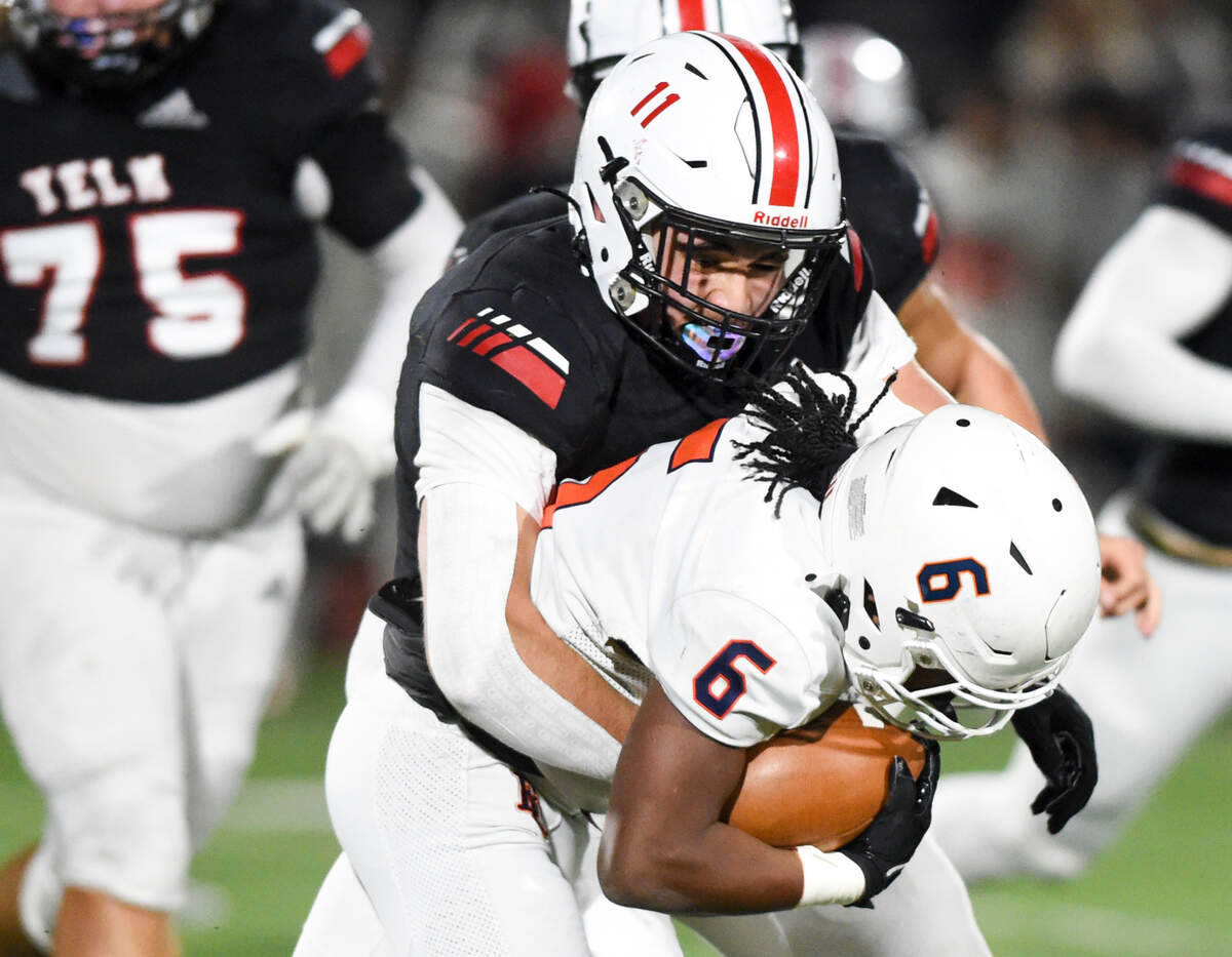 Yelm’s Jacob Tracy (11) tackles Eastside Catholic’s Jeremiah Burroughs (6) during the first half of the 3A semifinal state game at Art Crate Field, Saturday, Nov. 25, 2023, in Spanaway, Wash.