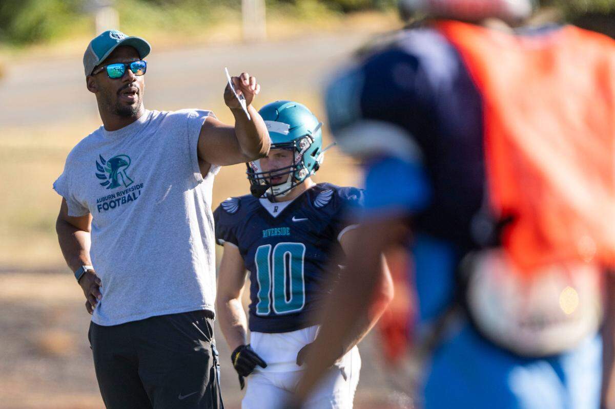 Auburn Riverside head coach Greg Herd directs his team during practice on Monday, Aug. 22, 2022, at Auburn Riverside High School in Auburn, Wash.