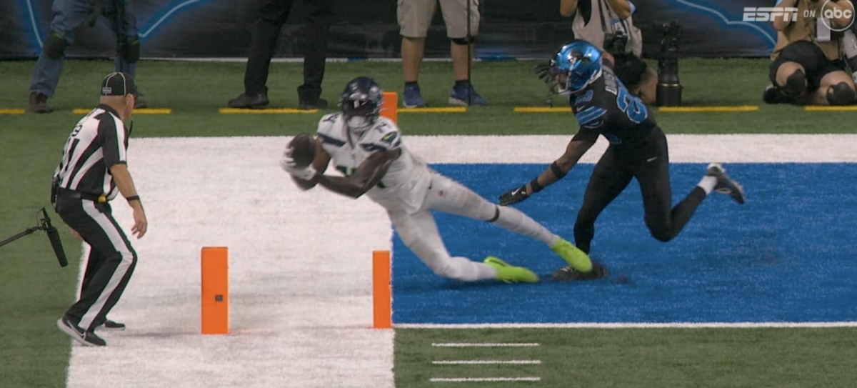 NFL line judge Rusty Baynes (left) ruled this catch by DK Metcalf (14) out of bounds and incomplete on a 2-point conversion try during the third quarter of the Seahawks’ loss at the Detroit Lions Sept. 30, 2024, at Ford Field in Detroit.