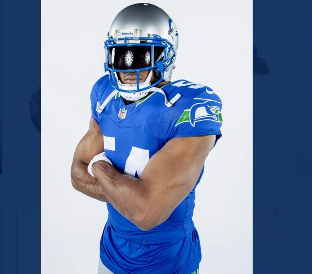 Seahawks captain Bobby Wagner shows off the 1990s, Kingdome-era throwback uniforms the team will wear for the Week 8 home game against the Cleveland Browns Oct. 29, 2023, at Lumen Field. Wagner calls the new-old threads “very fire.”