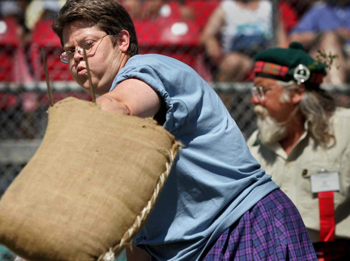 Laurie Jinkins of Tacoma competes in Scottish Athletic sheaf toss event during the 58th Annual Pacific Northwest Scottish Highland Games and Clan Gathering at the King County Fairgrounds in Enumclaw Sunday, August 1, 2004. Jinkins won the woman’s event by tossing the 10 pound bag over a 16 foot bar using a pitch fork.(Janet Jensen/The News Tribune)