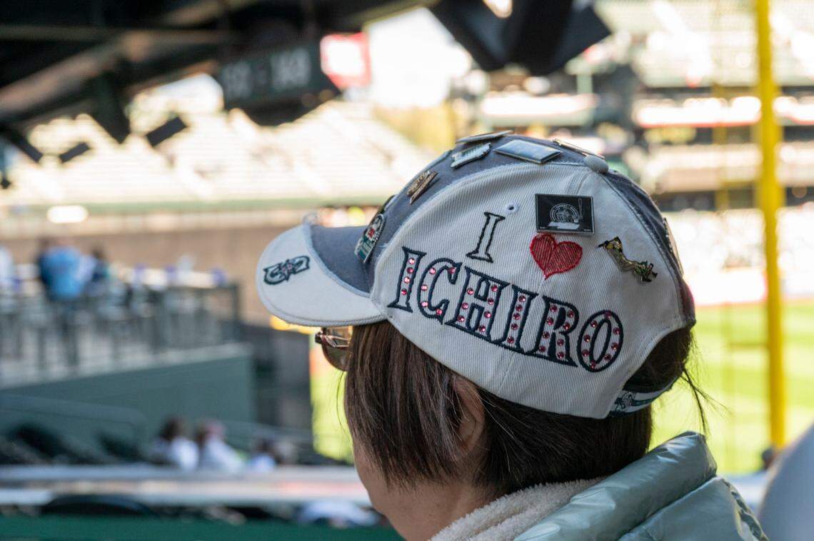 A woman sports an Ichiro-themed hat as she walks through the concourse prior to the start of the Mariners home opener at T-Mobile Park in Seattle on Friday, April 15, 2022.