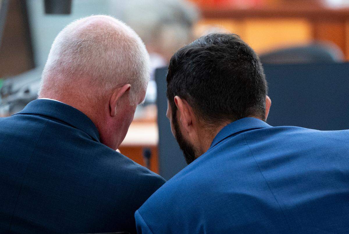 Defendant Christopher “Shane” Burbank talks with attorney Brett Purtzer in Pierce County Superior Court on Tuesday. Burbank and two colleagues with the Tacoma Police Department are on trial in the death of Manuel Ellis.