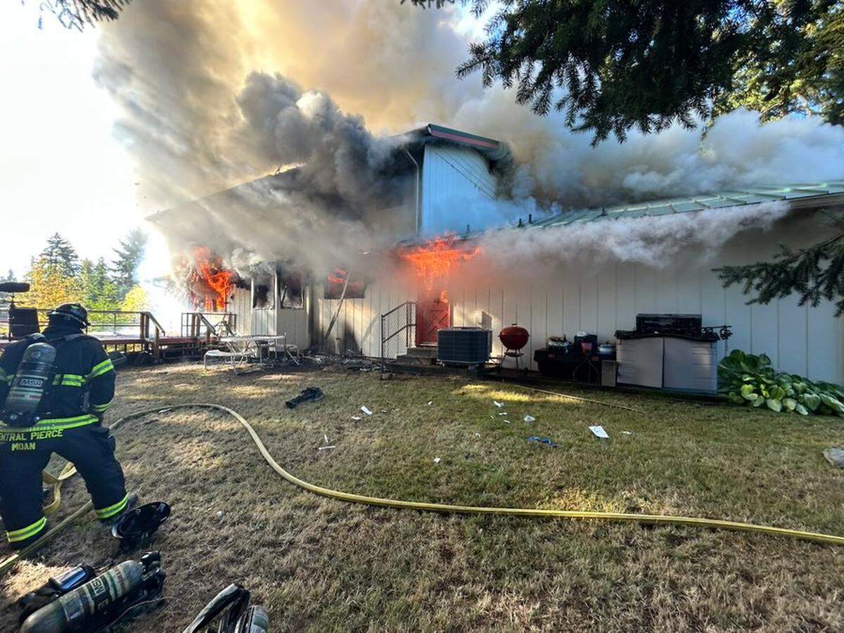 Central Pierce Fire & Rescue crews work to extinguish a fatal fire in a two-story residence Monday, Oct. 13, 2025 in Graham.
