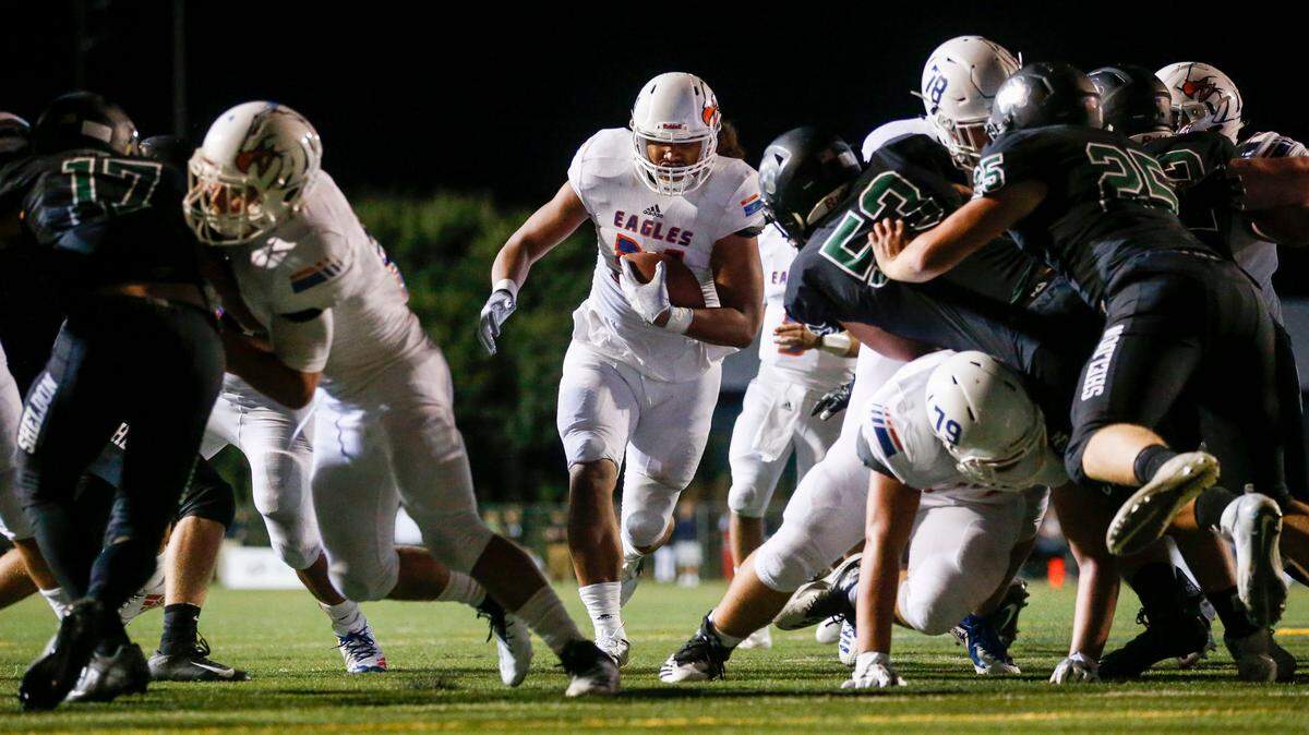 Graham Kapowsin running back Tommy Loa bursts through a hole on his way to the end zone at Sheldon High School.