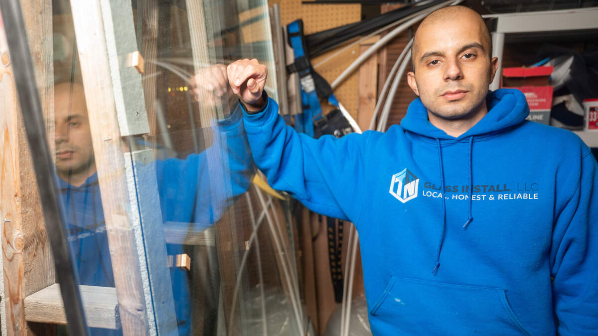 Nadeem Shariff, owner of TN Glass Install, poses for a portrait in his workshop in Tacoma on Wednesday afternoon. Shariff’s glass company has been replacing windows at businesses that have been targeted by vandalism. Shariff and his team are replacing the windows at Vien Dong, free of charge.