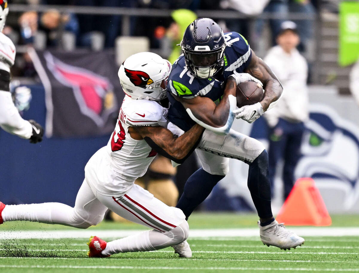 Seattle Seahawks wide receiver DK Metcalf (14) is tackled by Arizona Cardinals cornerback Sean Murphy-Bunting (23) during the first quarter of the game at Lumen Field, on Sunday, Nov. 24, 2024, in Seattle, Wash.