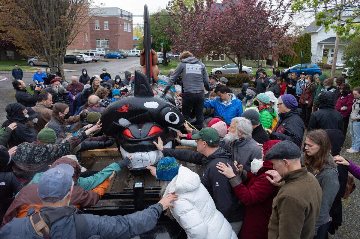 Bellingham community members gather to bless the House of Tears Carvers totem pole made for The Snake River to Salish Sea Spirit of the Waters totem pole journey at its launch Tuesday, May 3, 2022, at Bellingham Unitarian Fellowship in Bellingham, Wash. The 2,300-mile journey highlights the vital role of the Snake River, salmon and orca to the lifeways and identities of Tribal communities in the region.