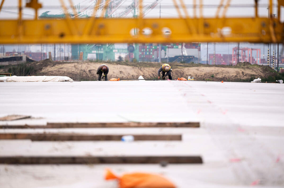 Construction workers make progress on a bridge to connect the new toll road to State Route 509, on Monday, Dec. 2, 2024, in Tacoma.