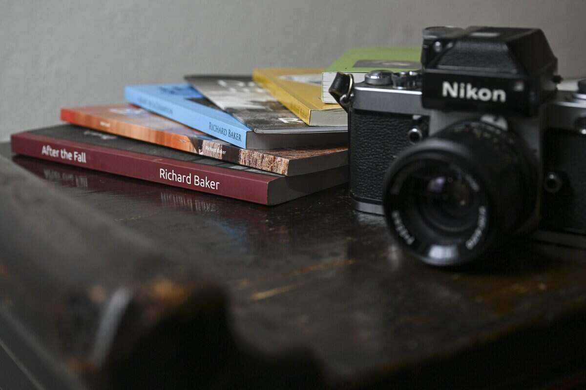 Books written by Richard Baker sit next to Baker's personal film camera on Tuesday, Jan. 20, 2026, in Tacoma, Wash.