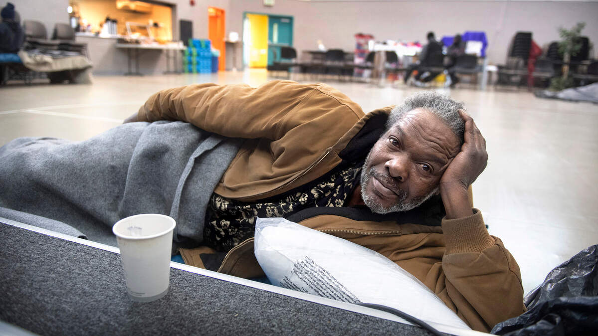 Tony McCreary sips a hot cup of tea as he rests at the R.I.S.E. warming center in Tacoma, Washington, on Tuesday, Dec. 28, 2021.