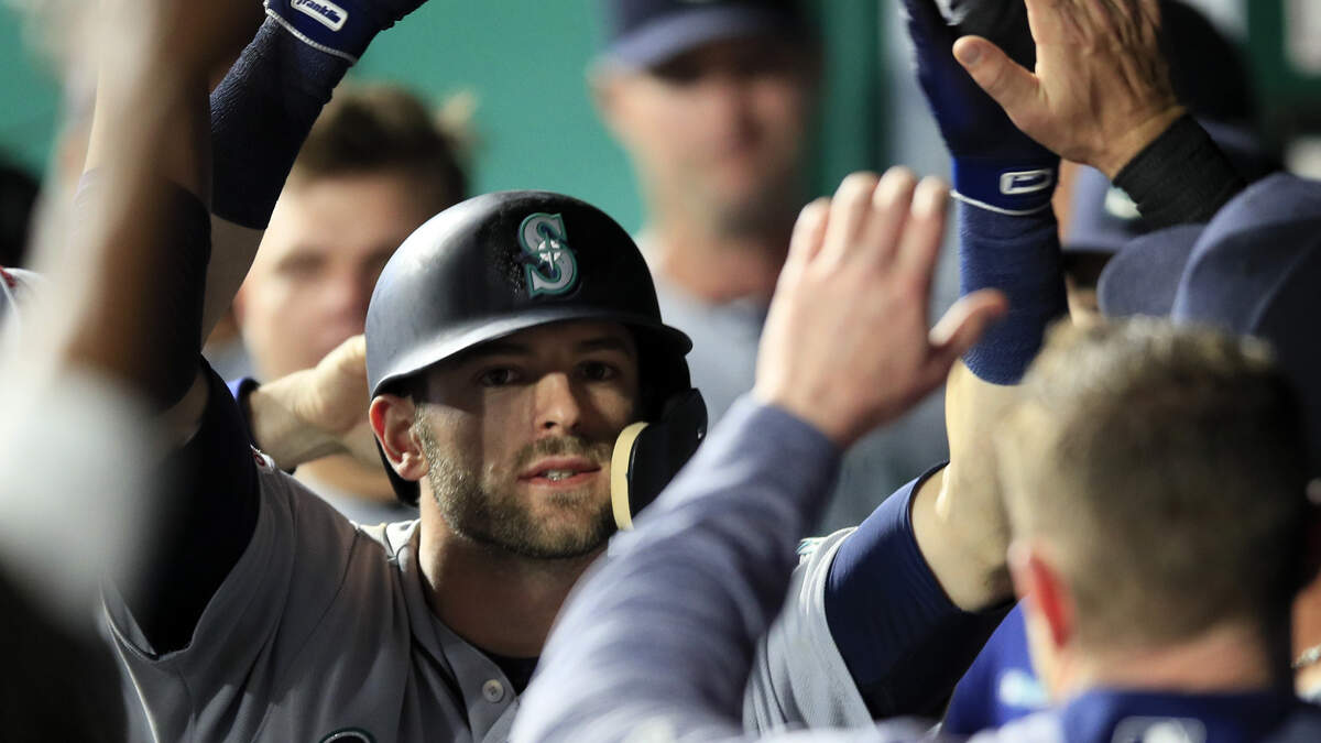 Seattle Mariners’ Mitch Haniger is congratulated by teammates after his solo home run during the ninth inning of the team’s baseball game against the Kansas City Royals at Kauffman Stadium in Kansas City, Mo., Wednesday, April 10, 2019. The Mariners defeated the Royals 6-5. (AP Photo/Orlin Wagner)