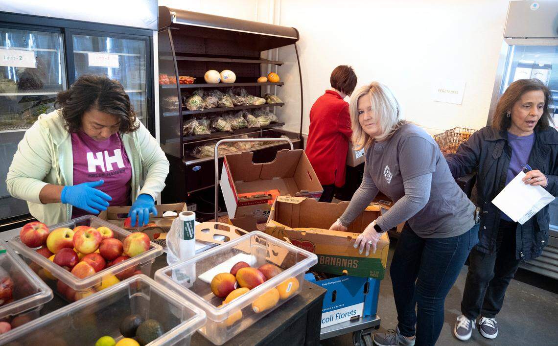 Volunteers (from left) Connie Newton of Tacoma, Vicki Armstrong of Lake Tapps, Darcel Whitezel of Bonney Lake and Margie Victor of Bonney Lake prepare fruits and vegetables for shoppers at the Sumner Community Food Bank in Sumner, Washington, on Wednesday, May 18, 2022.