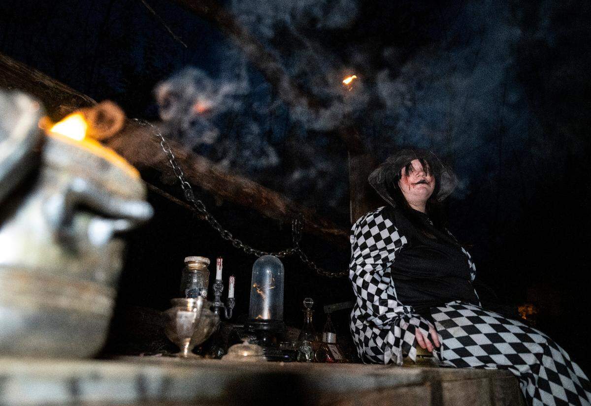 My Haunted Trail actor Chloe Brickles waits to scare people as they walk along the mile long trail at My Haunted Forest at Grand Farms in Vaughn, Wash. on Oct. 23, 2022.