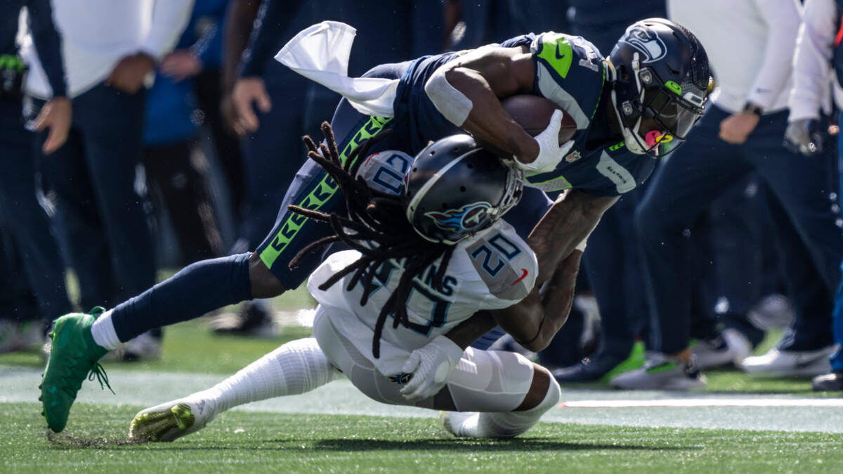 Tennessee Titans defensive back Jackrabbit Jenkins tackles Seattle Seahawks wide receiver DK Metcalf during the first half of an NFL football game, Sunday, Sept. 19, 2021, in Seattle. (AP Photo/Stephen Brashear)