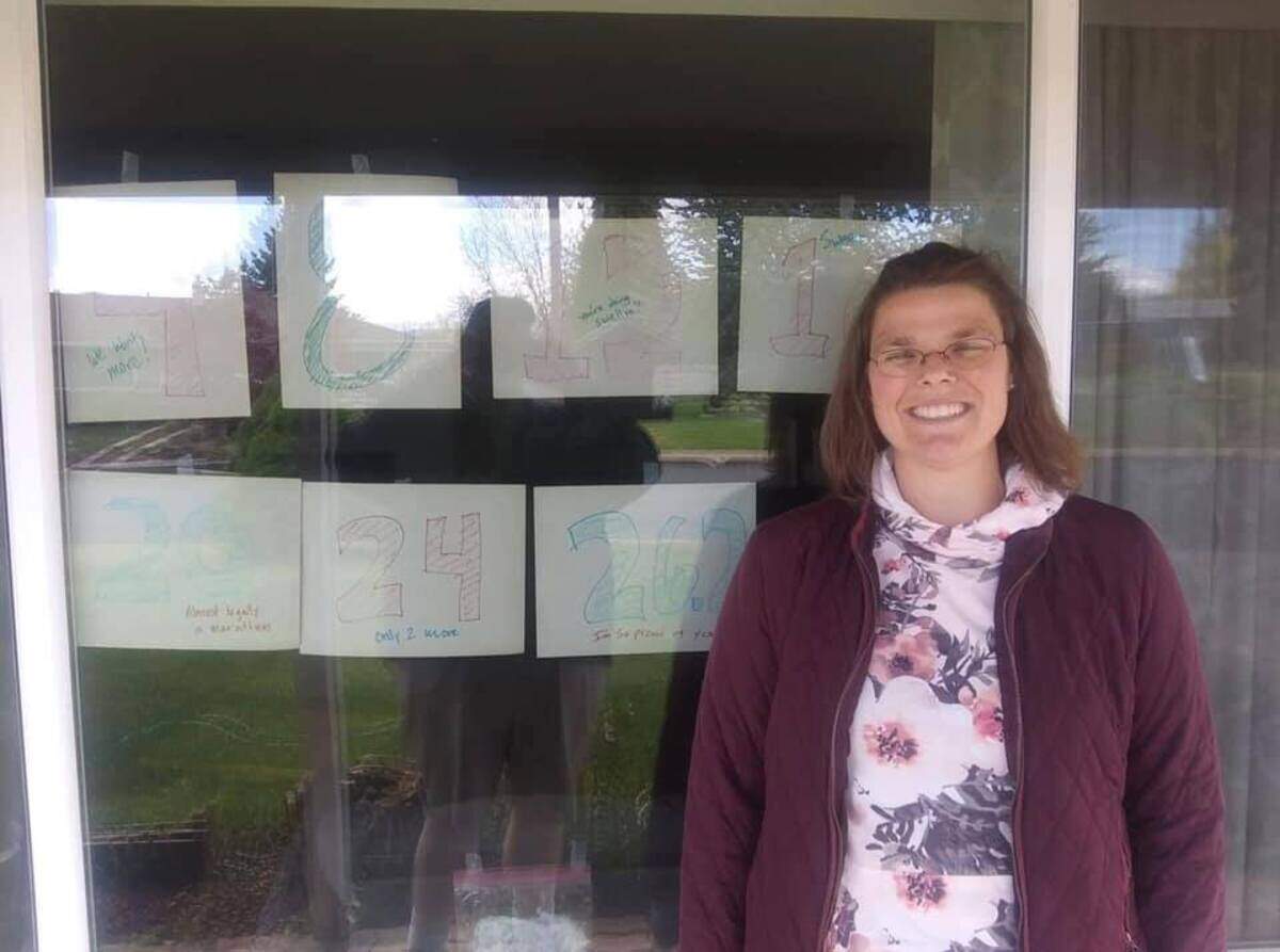 Lacey Gorrod’s husband taped signs in the window of their Goldendale home to track her mileage during a solo running challenge Saturday.