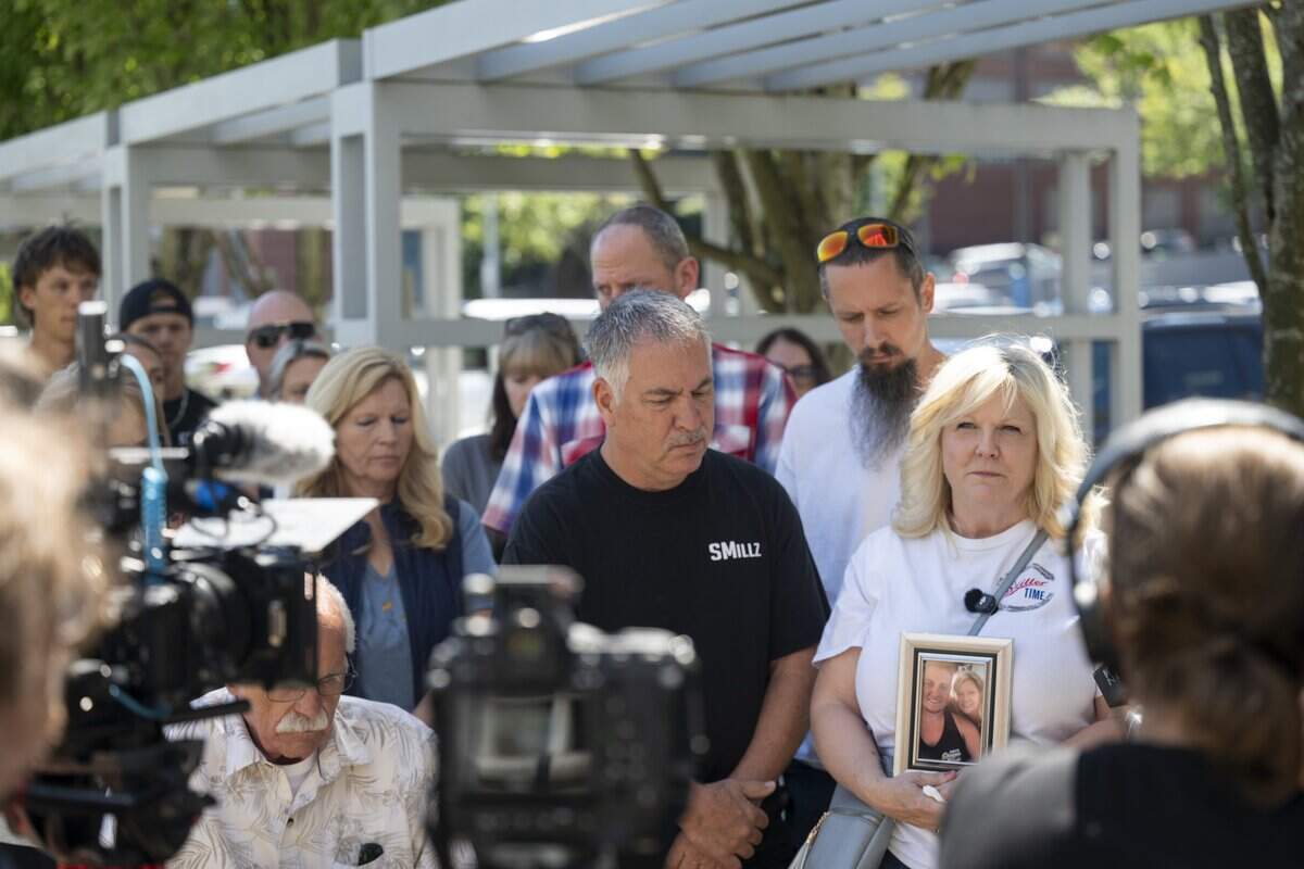 A crowd of family and friends of Sean Miller gather around his mother, Laura Zimmerman, right, after the arraignment of Chaston Pierce Philes on Tuesday, July 14, 2026, at Pierce County Superior Court in Tacoma, Wash. Philes was arraigned on charges of second-degree murder in the July 15, 2024 fatal shooting of Miller.
