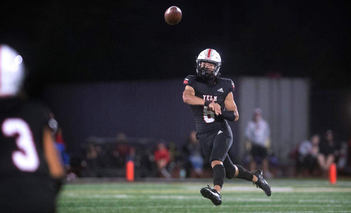 Yelm quarterback Damian Aalona fires a pass to wide receiver Tre Smith during Friday night’s season-opening football game against the Camas Papermakers at Yelm High School in Yelm, Washington on Friday, Sept. 2, 2022.