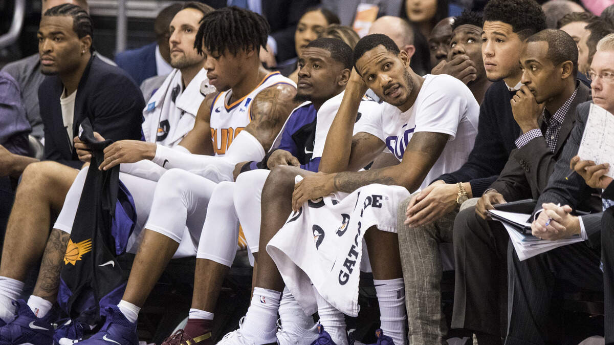 Players on the Phoenix Suns bench watch the action against the Sacramento Kings during the second half of an NBA basketball game, Tuesday, Dec. 4, 2018, in Phoenix. (AP Photo/Darryl Webb)