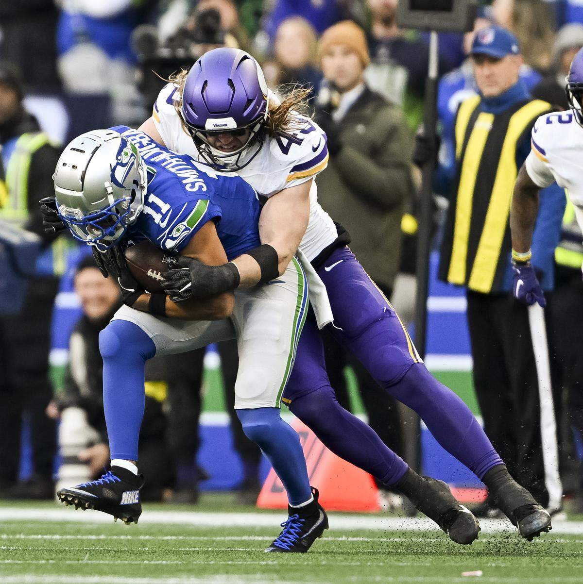 Seattle Seahawks wide receiver Jaxon Smith-Njigba (11) is tackled by Minnesota Vikings linebacker Andrew Van Ginkel (43) during the third quarter of the game at Lumen Field, on Sunday, Nov. 30, 2025, in Seattle.