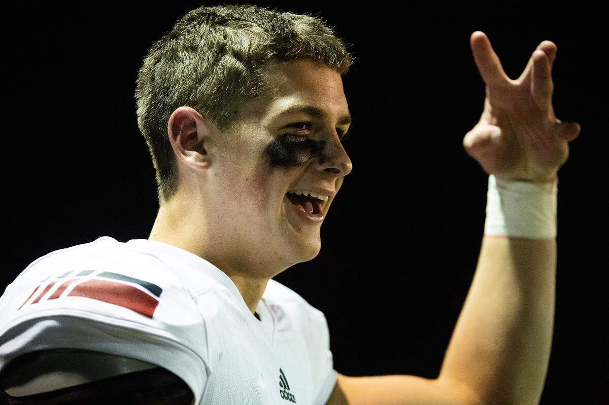 Kennedy Catholic’s Sam Huard makes a W sign with his hands while celebrating a Sav’ell Smalls sack. Kennedy Catholic played Enumclaw in a football game at the Enumclaw Expo Center in Enumclaw, Wash., on Friday, Oct. 4, 2019.